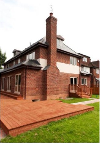 Rear elevation and timber deck — project photograph.