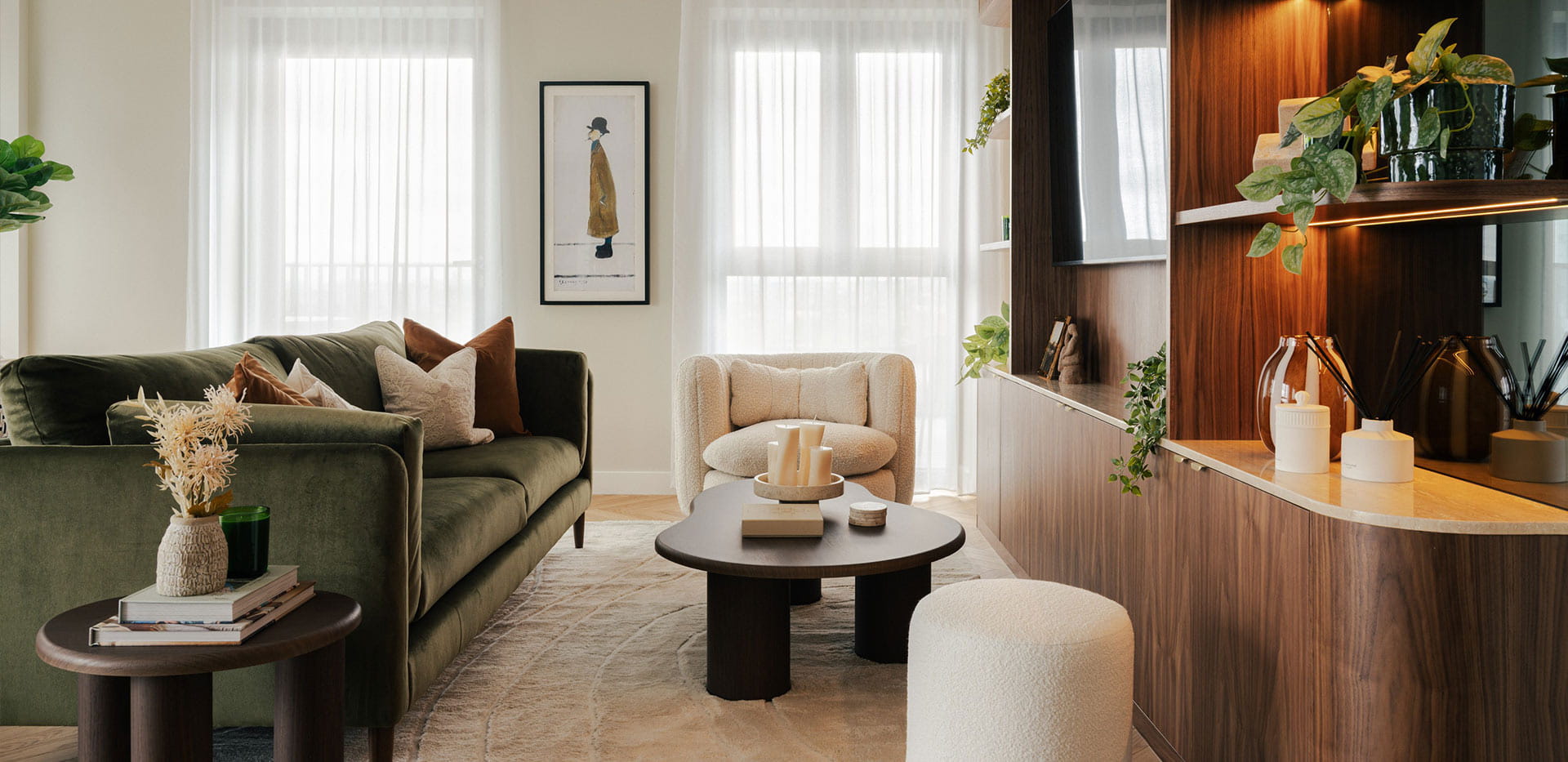 Living room with green velvet seating in a Crown Collection penthouse