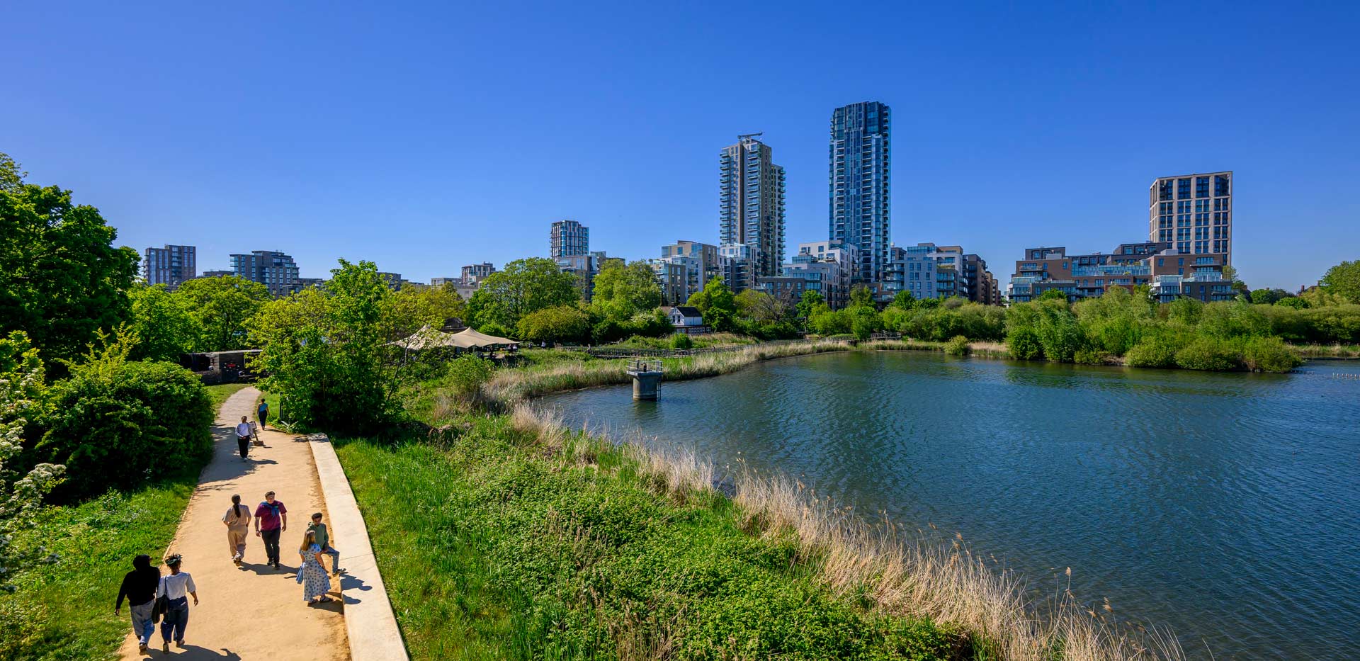 Waterside path with views of Woodberry Down apartment buildings