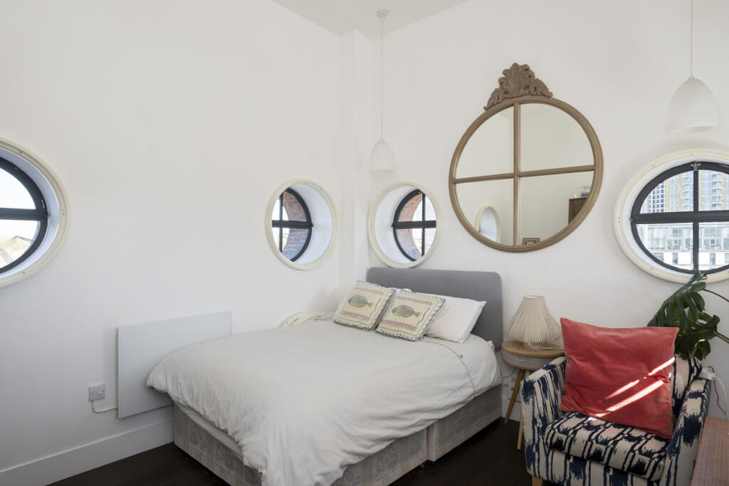 Bedroom with circular windows — George Mathers Road, London SE11