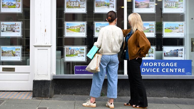 Two women looking at an estate agent window in Cardigan, Wales. Photo: Getty Images, via BBC News.